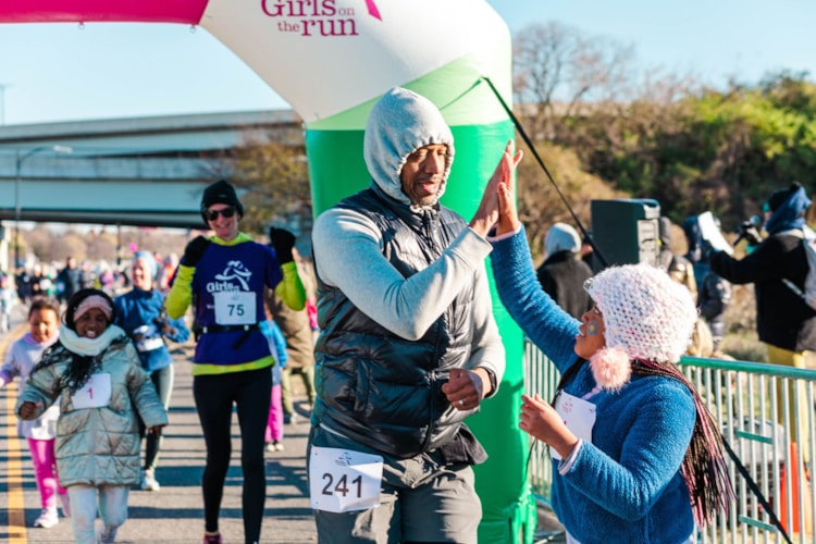 A GOTR Dad High-Fives at the Finish Line